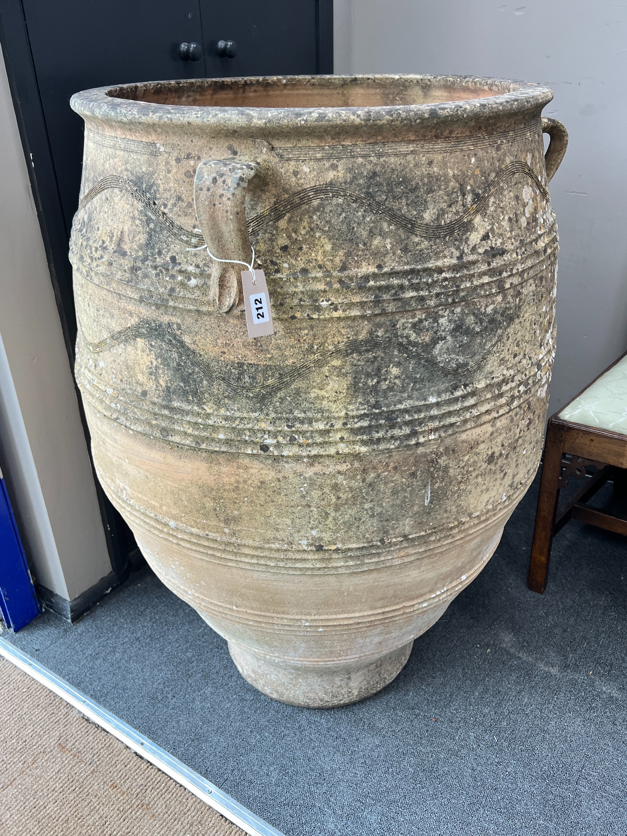 A large Grecian style incised terracotta oil jar, height 105cm